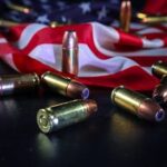 Close-up of ammunition over an American flag, symbolizing patriotism and freedom.